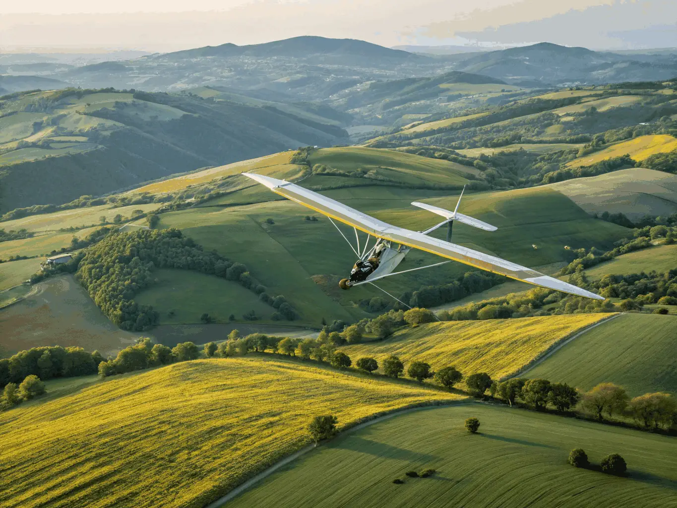 A dynamic image of an ultralight aircraft in flight, showcasing its maneuverability and the stunning views from above. The image should capture the excitement and freedom of ultralight aviation.